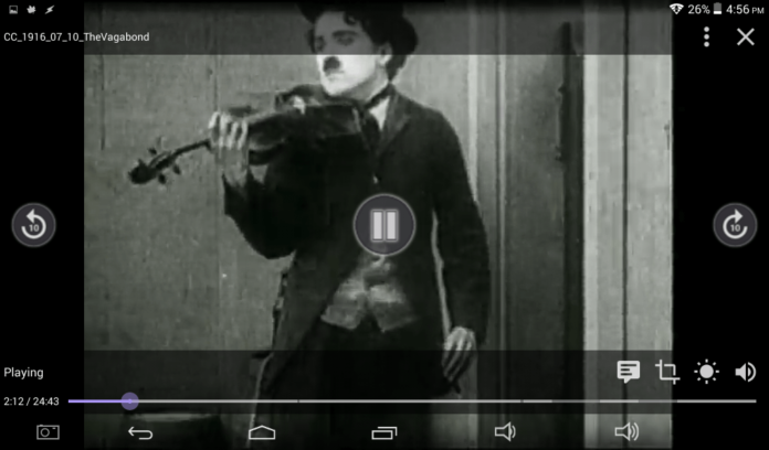 A screenshot of Charlie Chaplin playing violin on the movie Vagabond from the year 1916