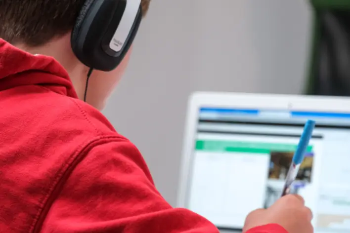 A person learning infront of a computer screen