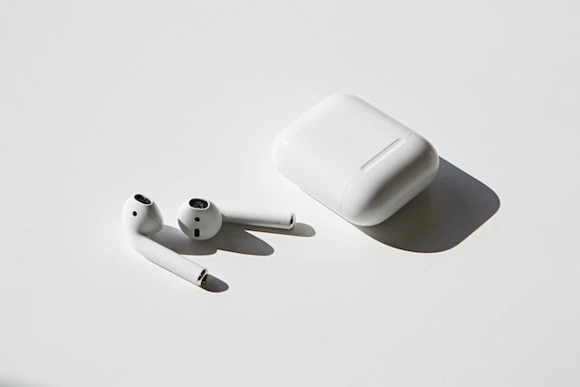 A picture of apple airpods on display with the airpods out of the charging box